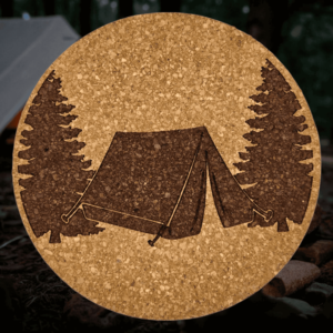 Round natural camping tent cork coaster featuring a detailed laser-engraved A-frame tent and evergreen pine trees design