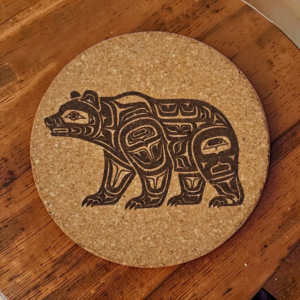 Round natural bear cork coaster featuring a detailed laser-engraved tribal style bear design