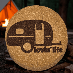 Round natural vintage camper cork coaster featuring a bold laser-engraved retro teardrop trailer and lovin life text