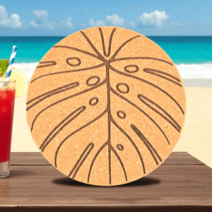 Round natural monstera cork coaster featuring a detailed laser-engraved tropical leaf pattern