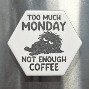 A white hexagon funny Monday coffee magnet featuring an exhausted creature and text reading Too Much Monday Not Enough Coffee